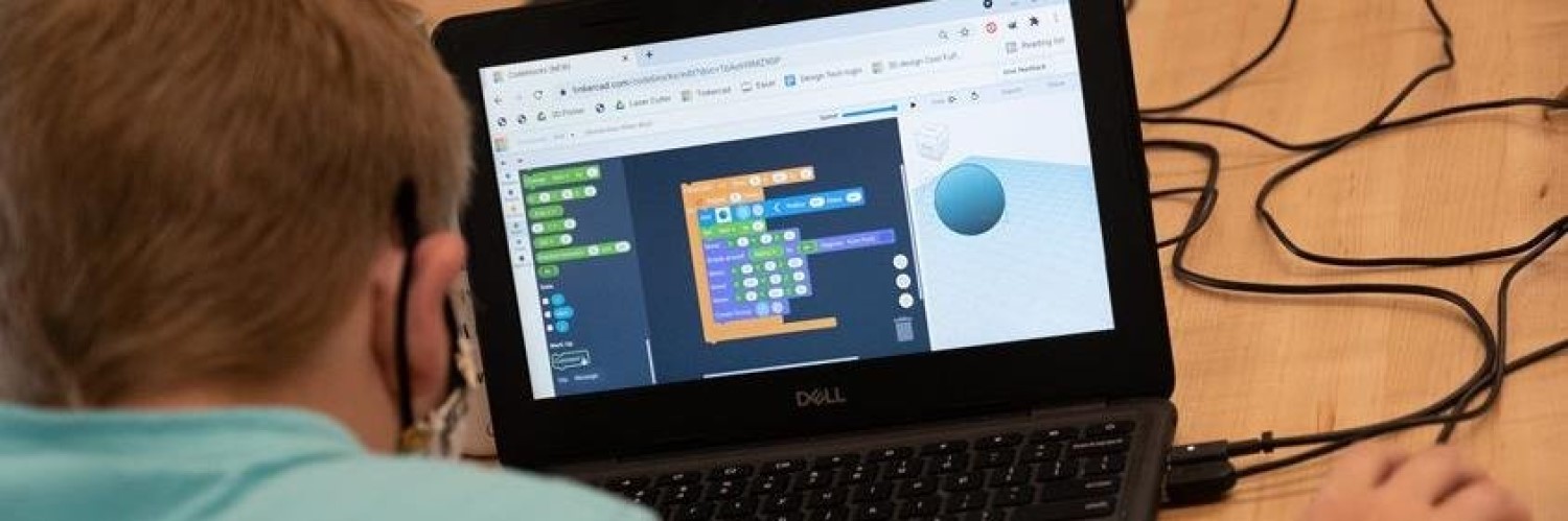 Image of kids designing a complex drawing on a computer