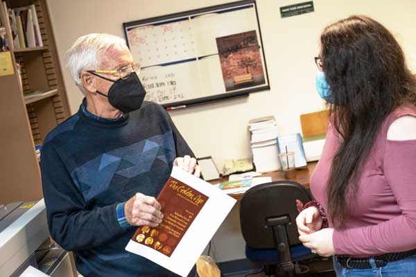 Phil Hauck and student bind book