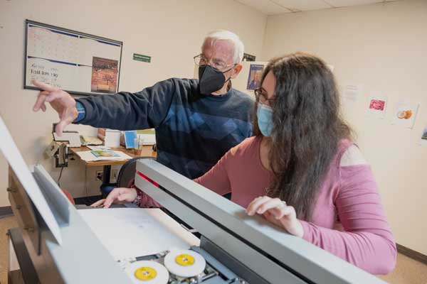 Phil Hauck and student work with Teaching Press Equipment