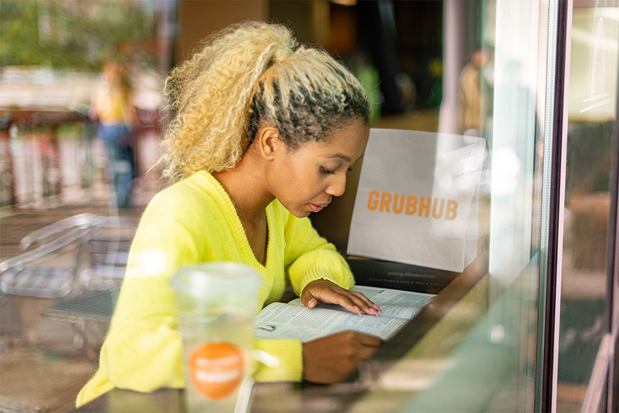 Student studying while enjoying their Grubhub food delivery