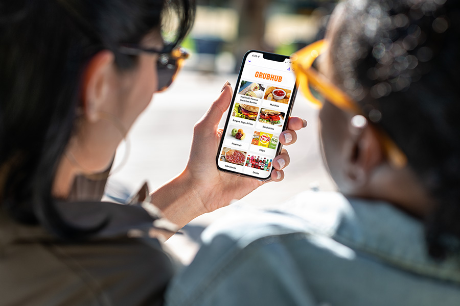 Two students browse the Grubhub app together