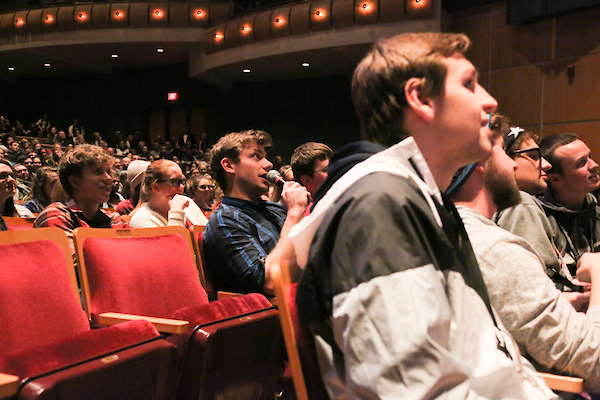 Comedian Charlie Berens sits among a crowd of students at the Weidner Center in Cofrin Family Hall