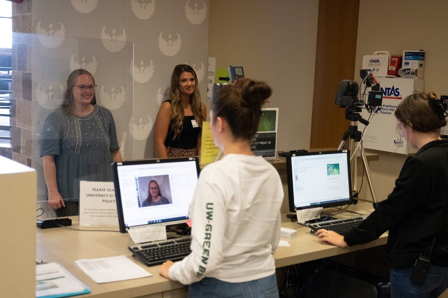 Two students getting photo taken for student ID