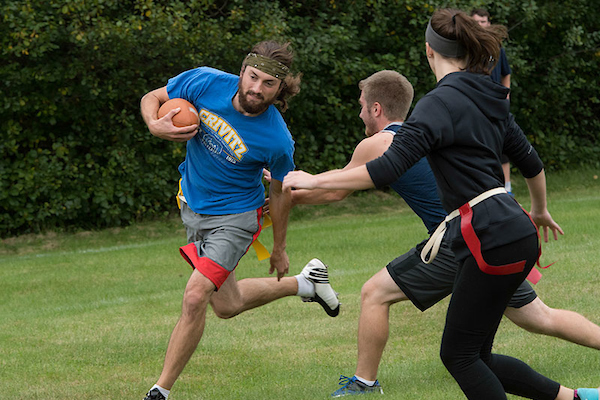Students play flag football outdoors on the Marinette campus