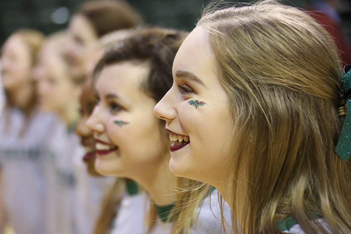 student smiling while attending a game.