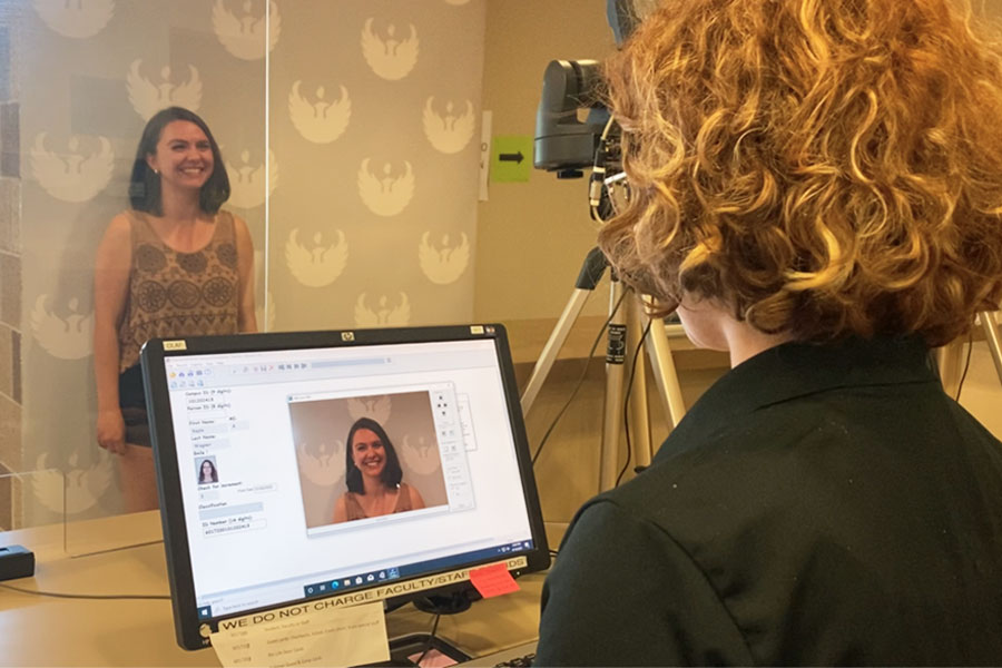 Student gets their photo taken for a student ID