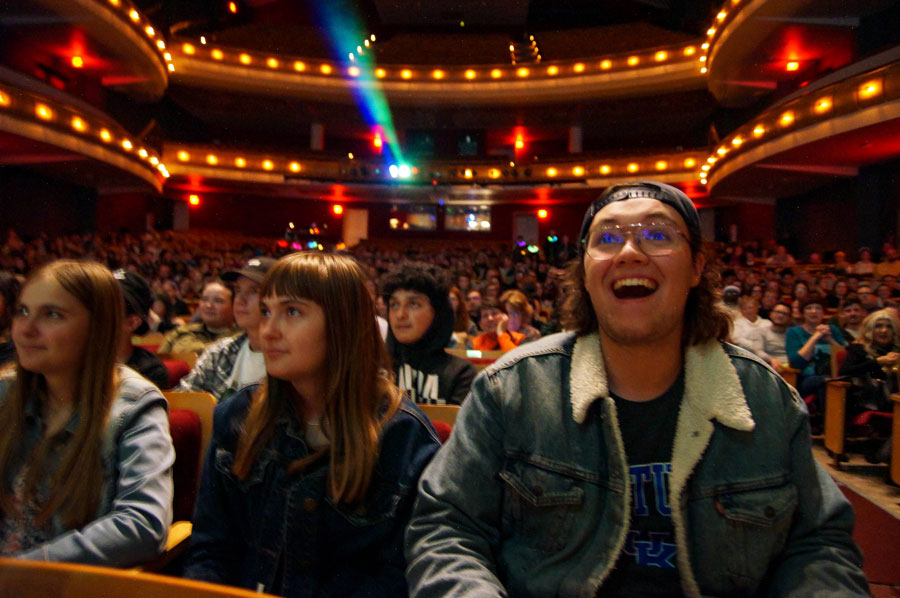 Crowd of students smiling with excitement during show at Weidner Center