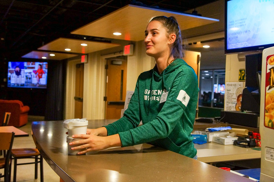 UW-Green Bay student employee serving soup in to go containers