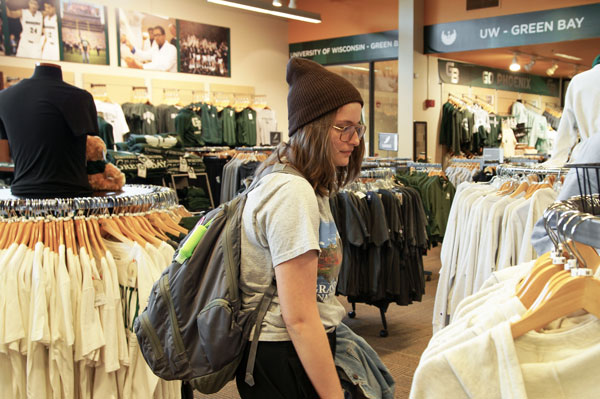 Female student wearing a hat shops at university book store