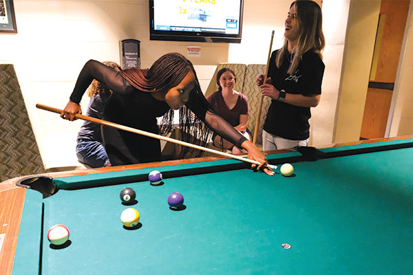 Group of female students playing pool