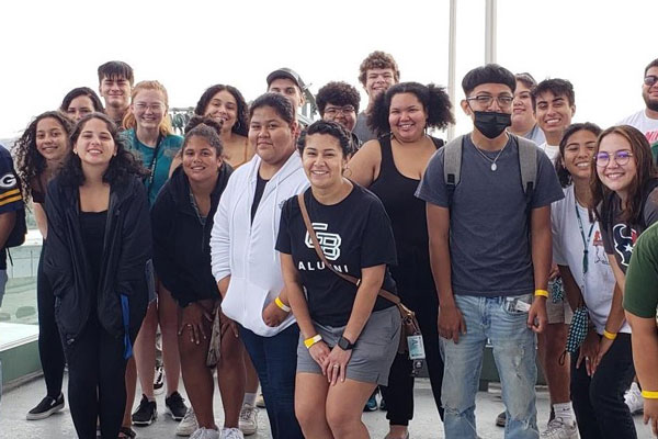 Group of students in multi-ethnic students smile for photo