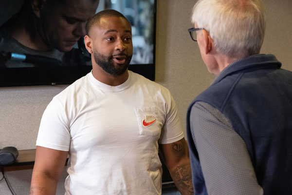 Governer Evers speaks with Starz barber shop owner Chris Kimbrough