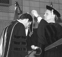 UW System President Kenneth Shaw (right) presents Chancellor David Outcalt with the University medallion at Outcalt's inauguration ceremony.