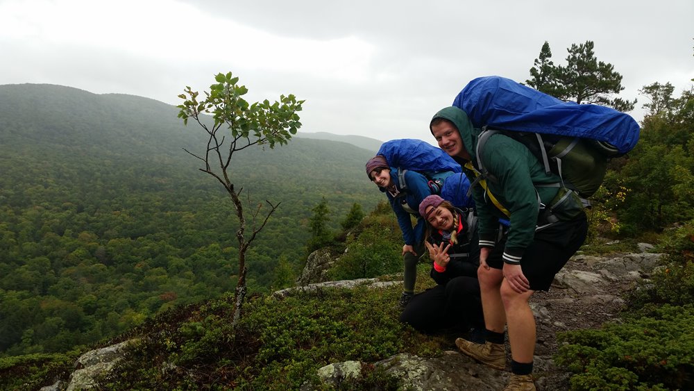 Students on hike giving peace sign