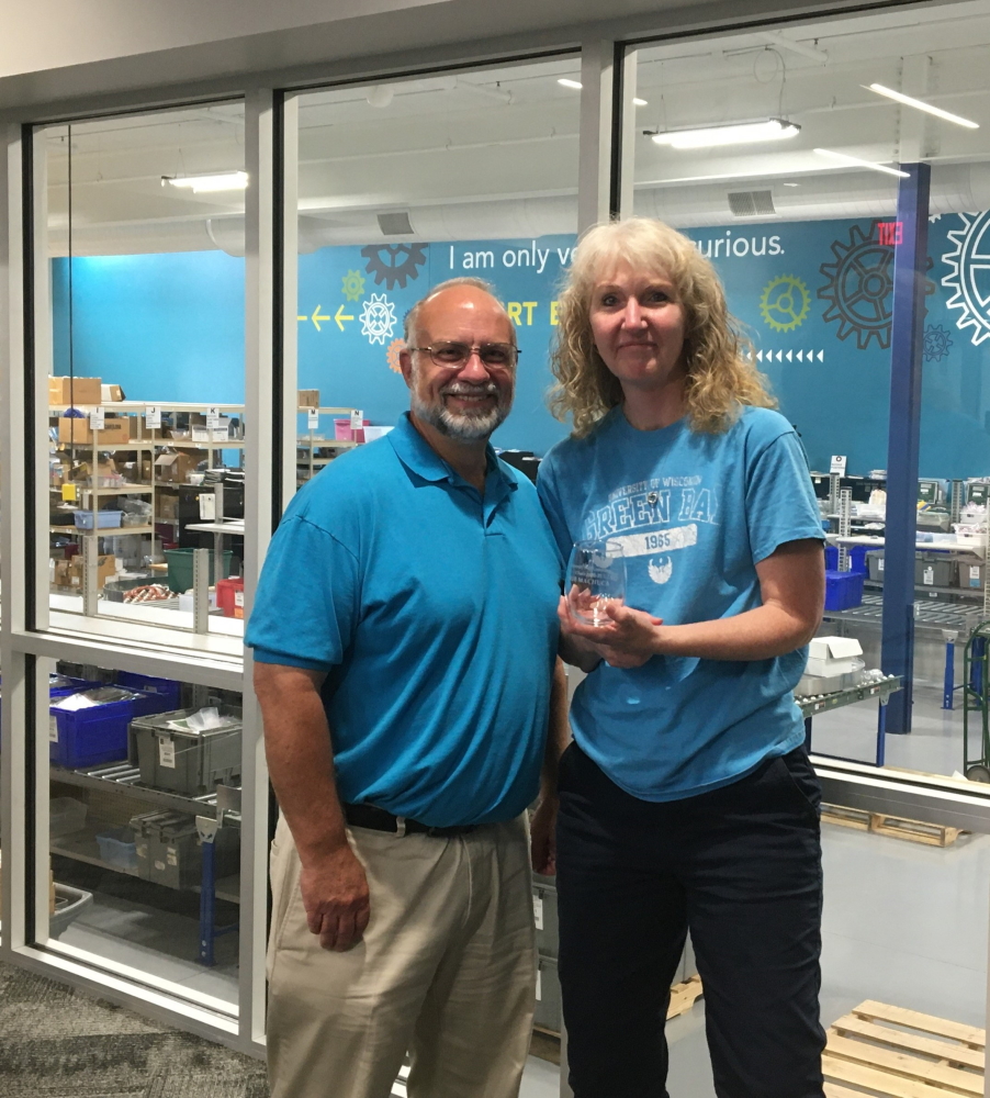 Sue Machuca receiving an award from Steve Meyer