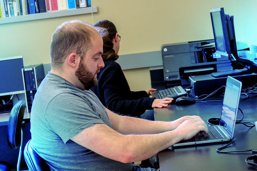 Veteran students work at computers