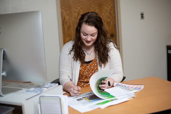 Student employee works at desk