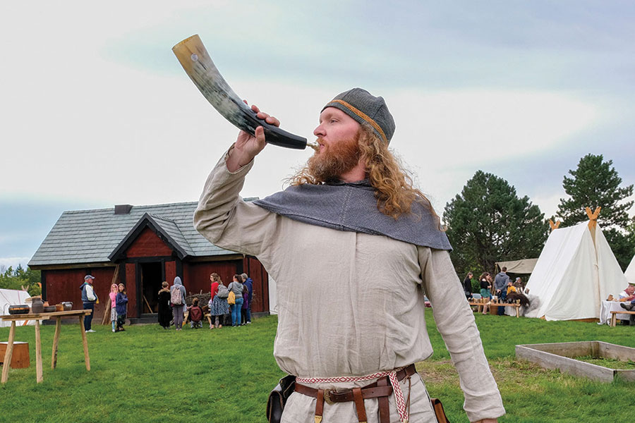 Sven Tunheim blowing into a Viking horn.