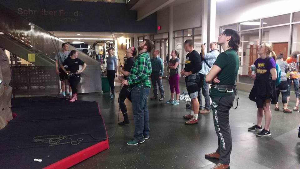 students using the UREC Climbing wall