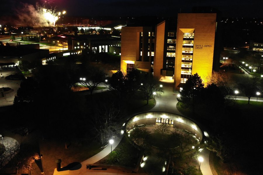 Campus buildings are lit up by lights during nighttime