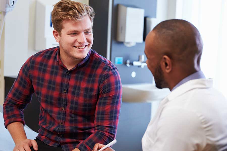 Student talks with doctor at medical appointment