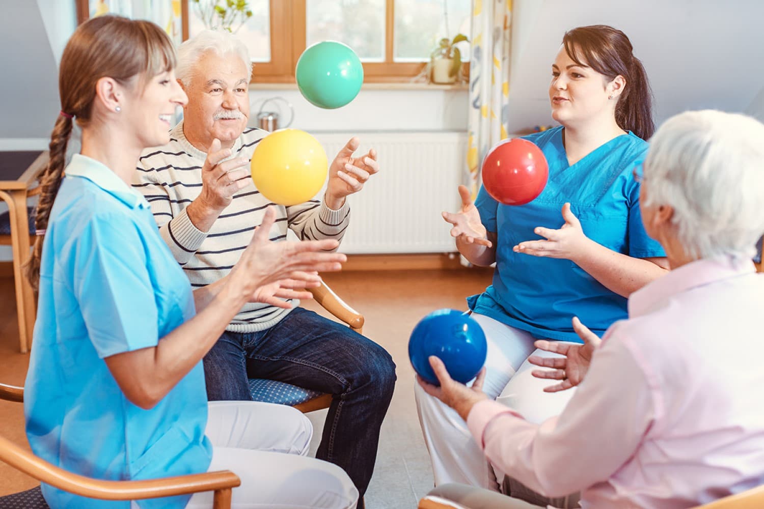 caregiver leading exercise class at an assisted living facility
