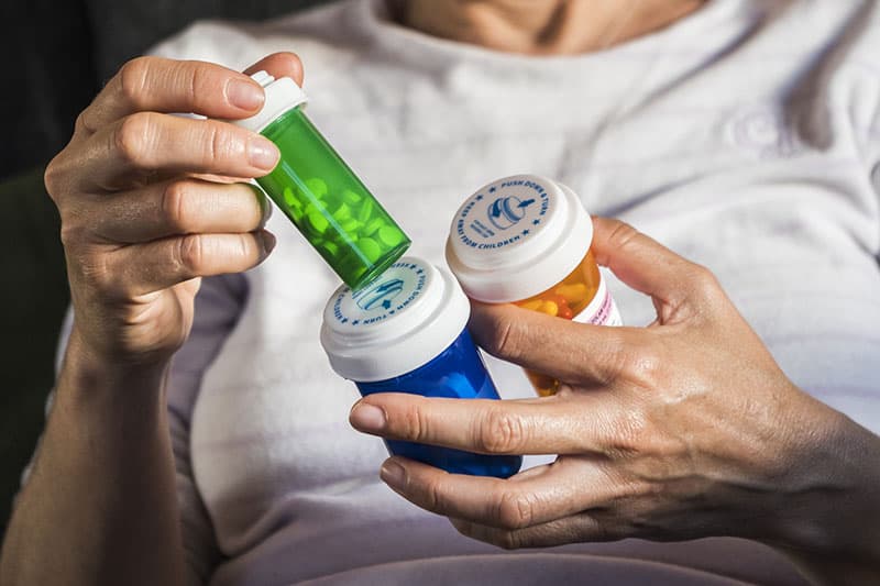 Person looking at medication bottles