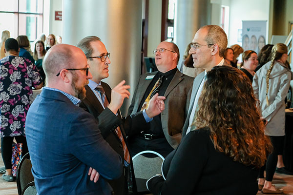 Chancellor alexander talking with event attendees