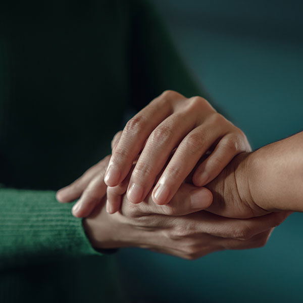 Close up of hands offering support