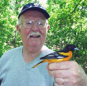 Dr. Cofrin with a baltimore oriole.
