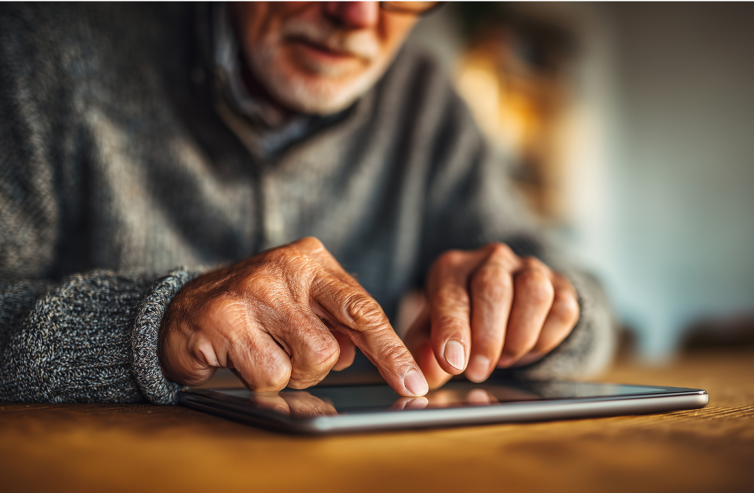 older man using electronic tablet