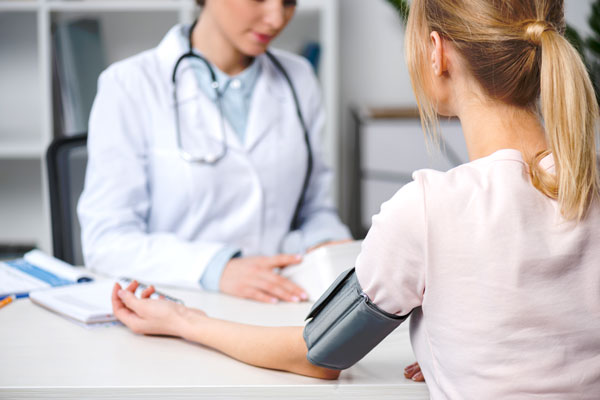Nurse takes patients blood pressure