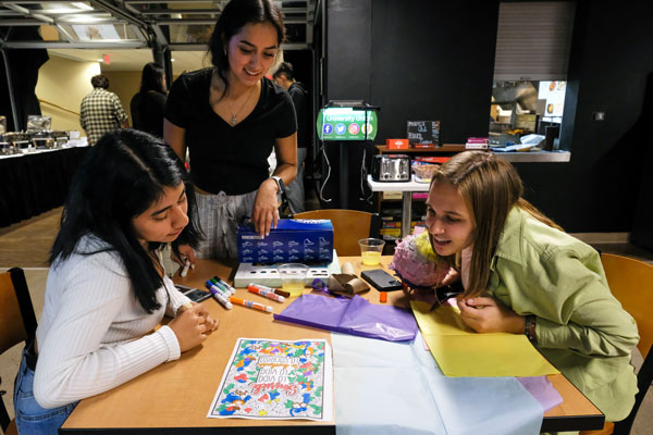 Three students participating in Latinx event in the Phoenix Club