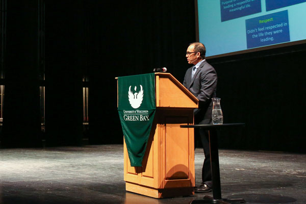 Male in suit gives speech at Common Cahhs event