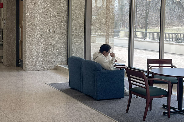 Student studying in front of a window