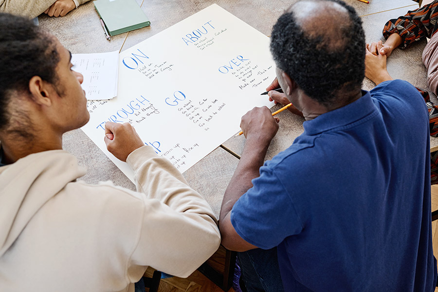 Two men working on learning english language