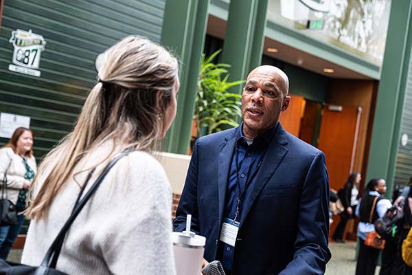 man and woman talking during networking opportunity