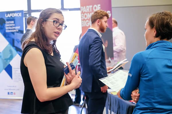 Professory speaks with students about potential careers at job fair
