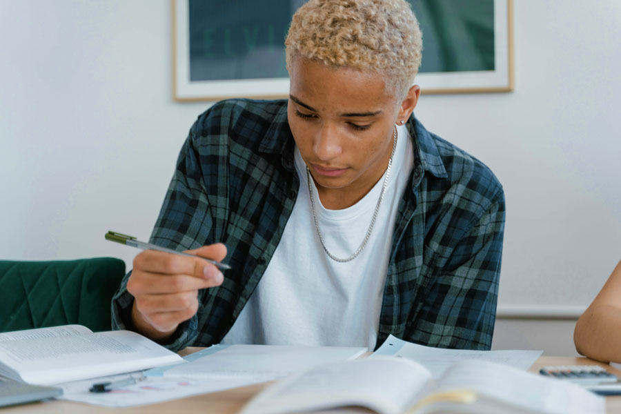 Student taking notes while studying