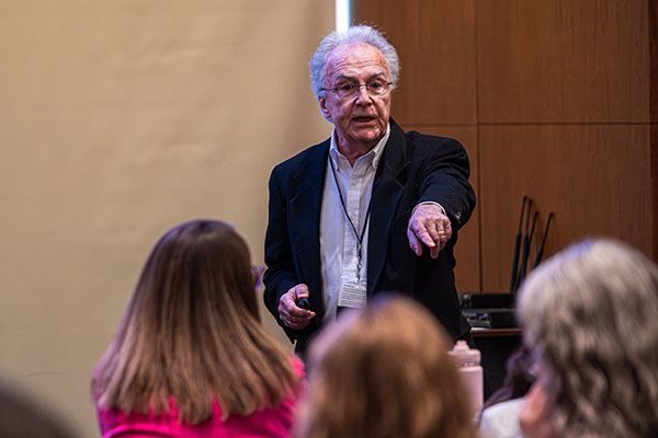 man speaking to attendees during breakout session