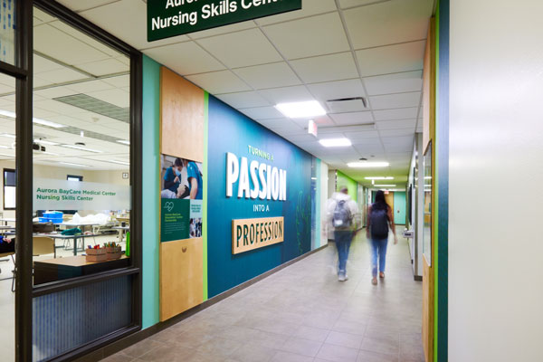 Students walking past Aurora nursing lab