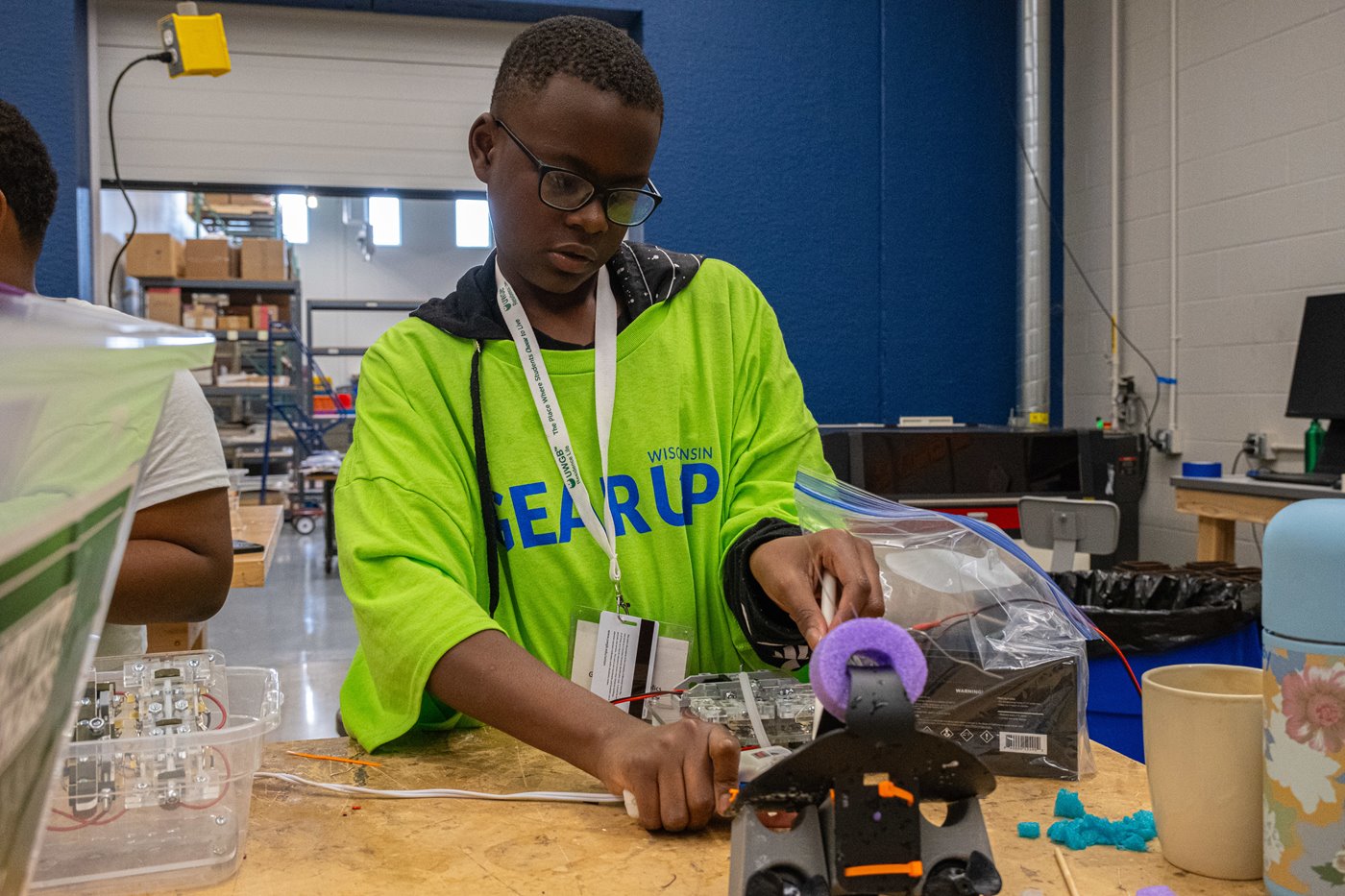 camper working on robotics project