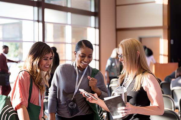 three women at conference expo