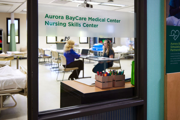 Student meets with professor in Aurora nurse lab