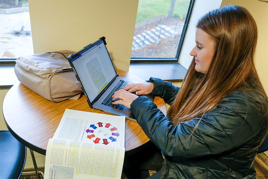 MS Management student Brinley Kowalkowski studies before class inside the Cofrin School of Business Wood Hall's study area at the UW-Green Bay campus on Oct. 20, 2022. 