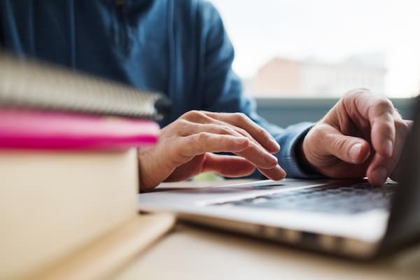 Close up of person typing on computer