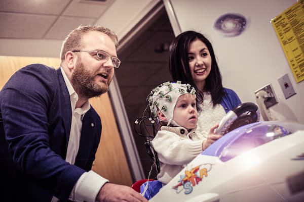 Dr. Jason Cowell and Dr. Sawa Senzaki preform eeg on child