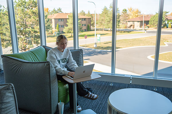 Student studying in a UWGB housing lounge.