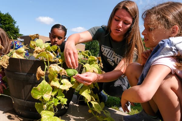 Student gardening with the Boys and Girls Club of Green Bay