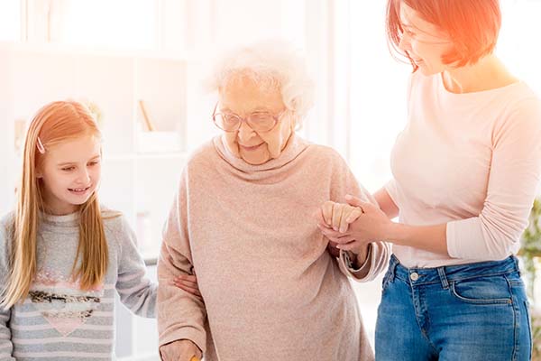helping senior woman walk